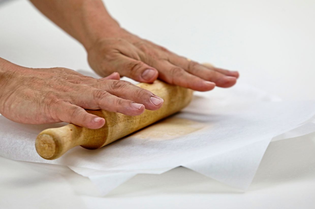 Roll out each portion of dough into discs and spread one-third of filling into each disc.